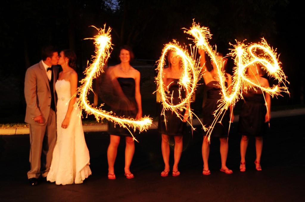 Bridesmaids spell "love" with sparklers