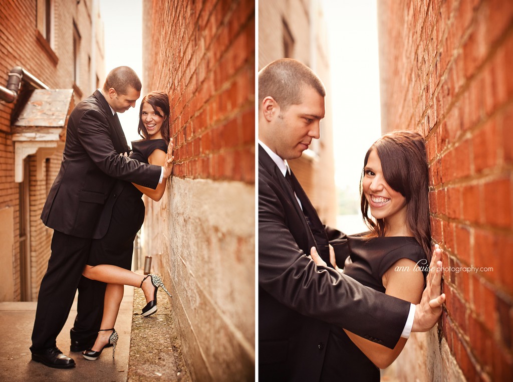 Engagement photo of couple leaning on brick wall. Ann Louise Photography