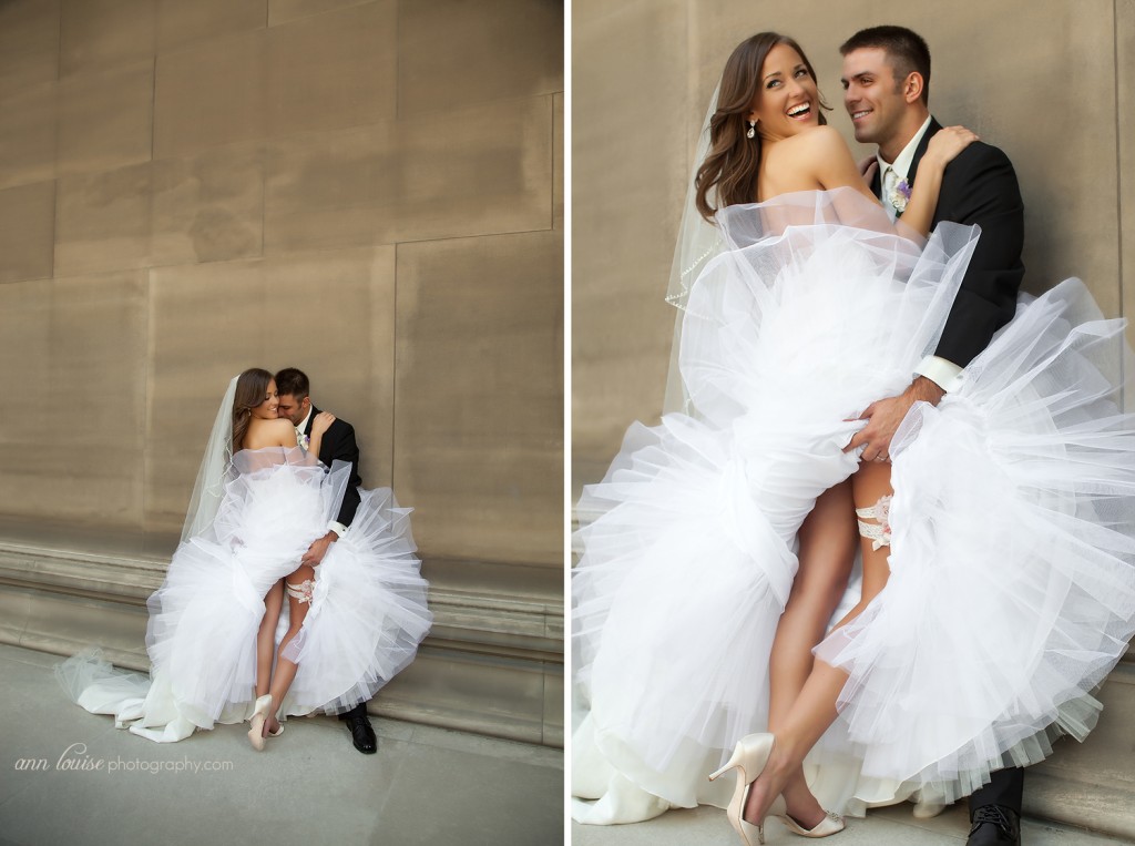 Wedding picture: Bride and groom posing with garter showing. Ann Louise Photography