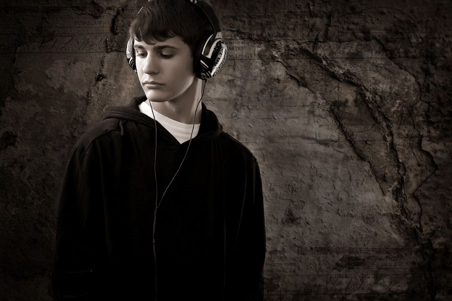 Portrait of boy with headphones by Kirk Voclain Photography