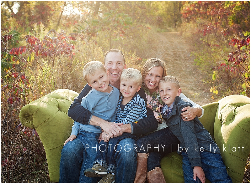 Portrait of family outside on couch by Kelly Klatt Photography