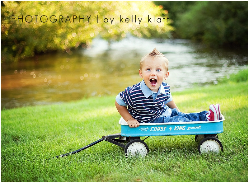Little boy posing in front of lake by Kelly Klatt Photography