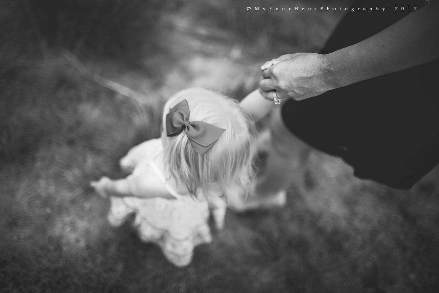 Portrait of little girl walking, holding her mom's hand by My Four Hens Photography