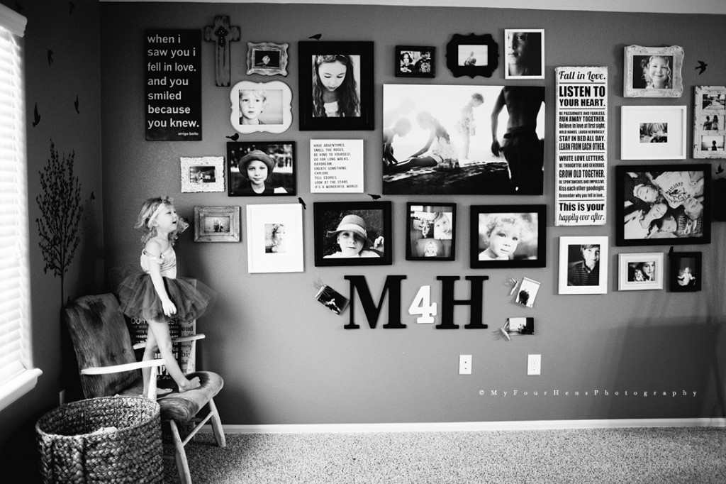 Portrait of little girl in front of collaged wall by My Four Hens Photography