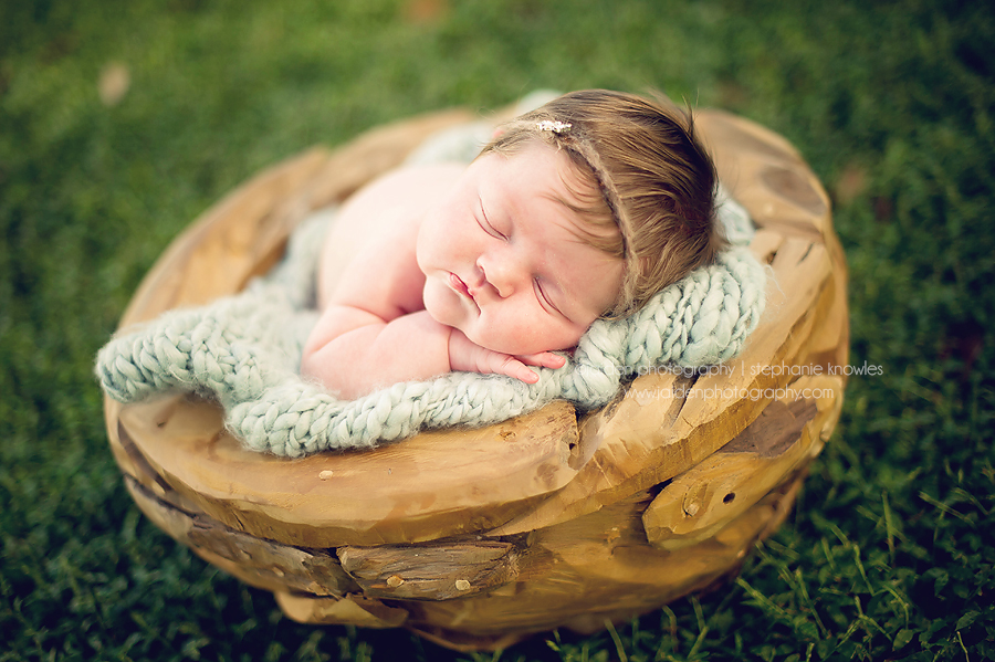 Portrait of a newborn outside in a basket by Jaiden Photography