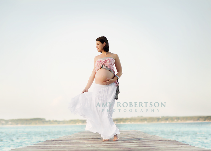 Maternity portrait of mom looking out at the lake by Amy Robertson Photography