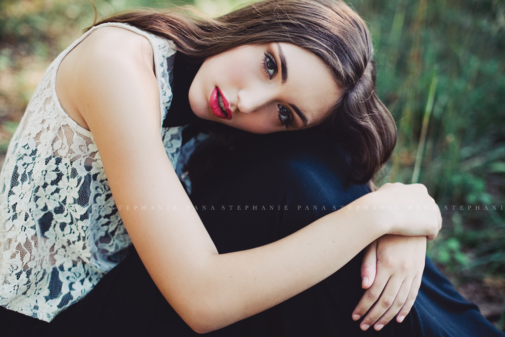 Portrait of senior girl hugging her knees by Stephanie Pana