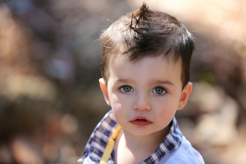 Portrait of little boy with mowhawk by Anja McDonald
