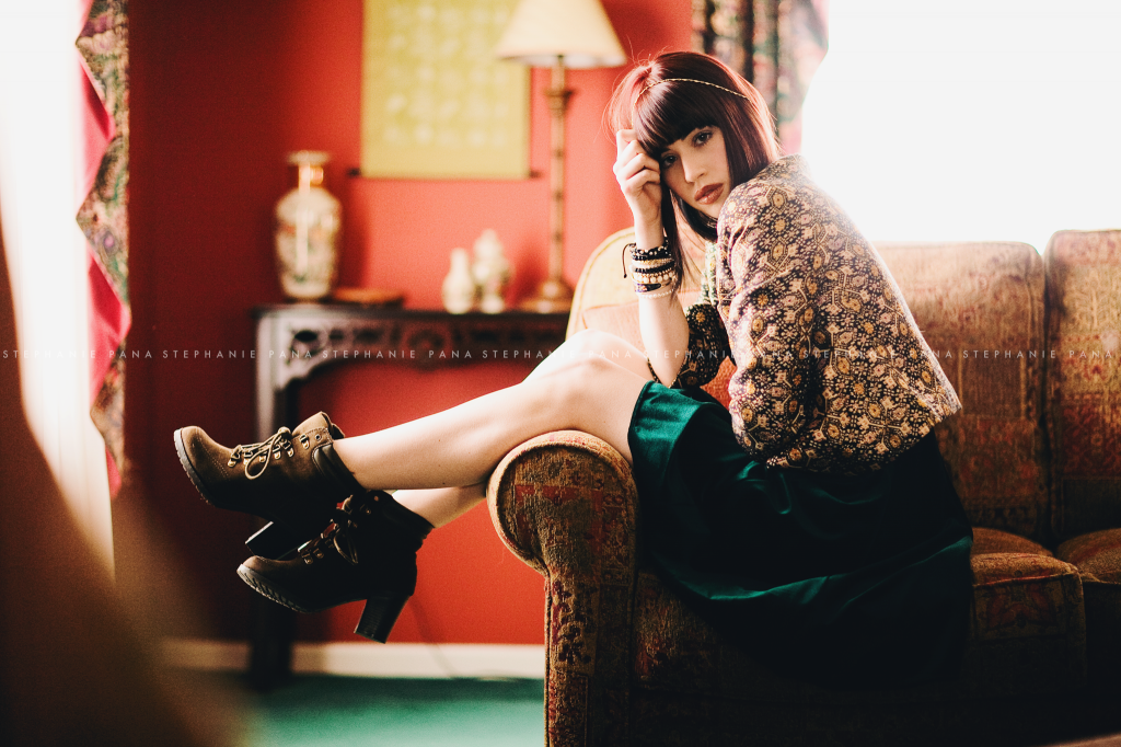 Portrait of Senior girl sitting on sofa by Stephanie Pana Photography
