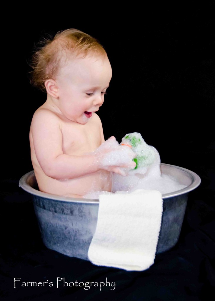 Portrait of baby in bathtub by Farmer's Photography