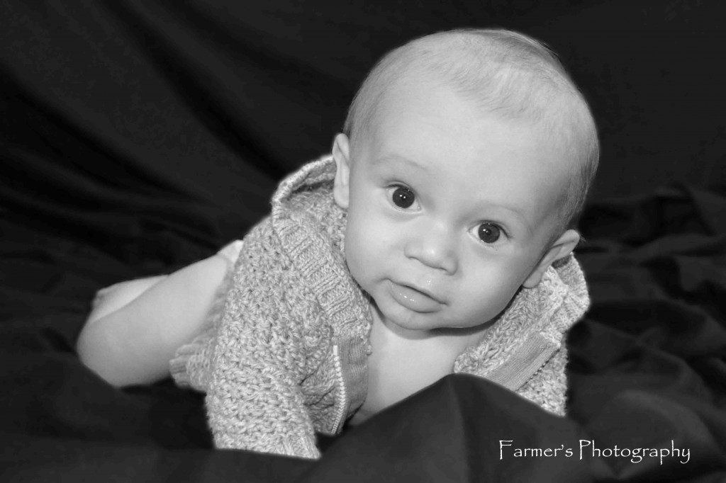 Portrait of baby laying on stomach by Farmer's Photography
