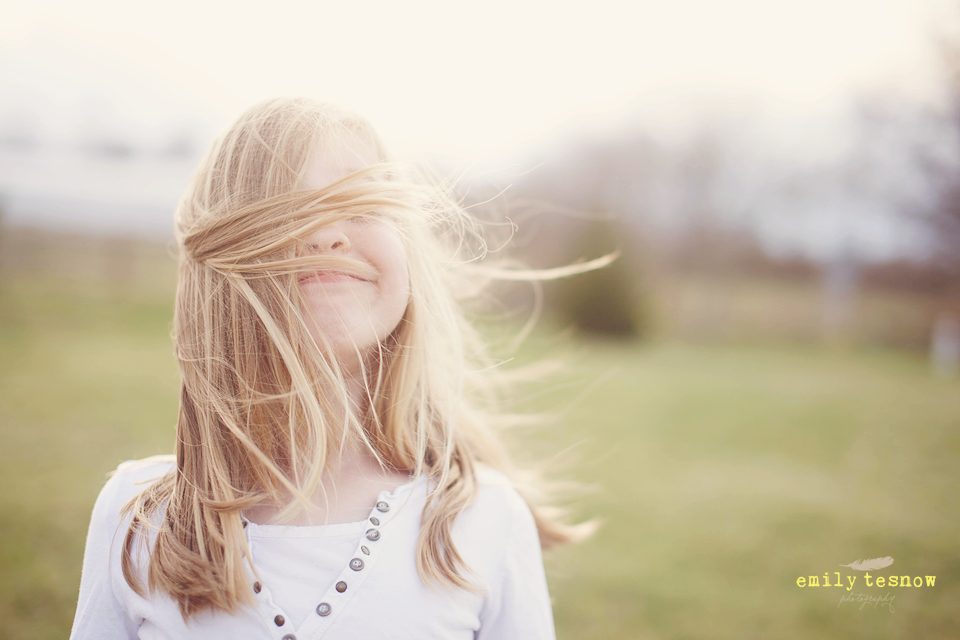 Portrait of young with with hair blowing in wind by Emily Tesnow Photography