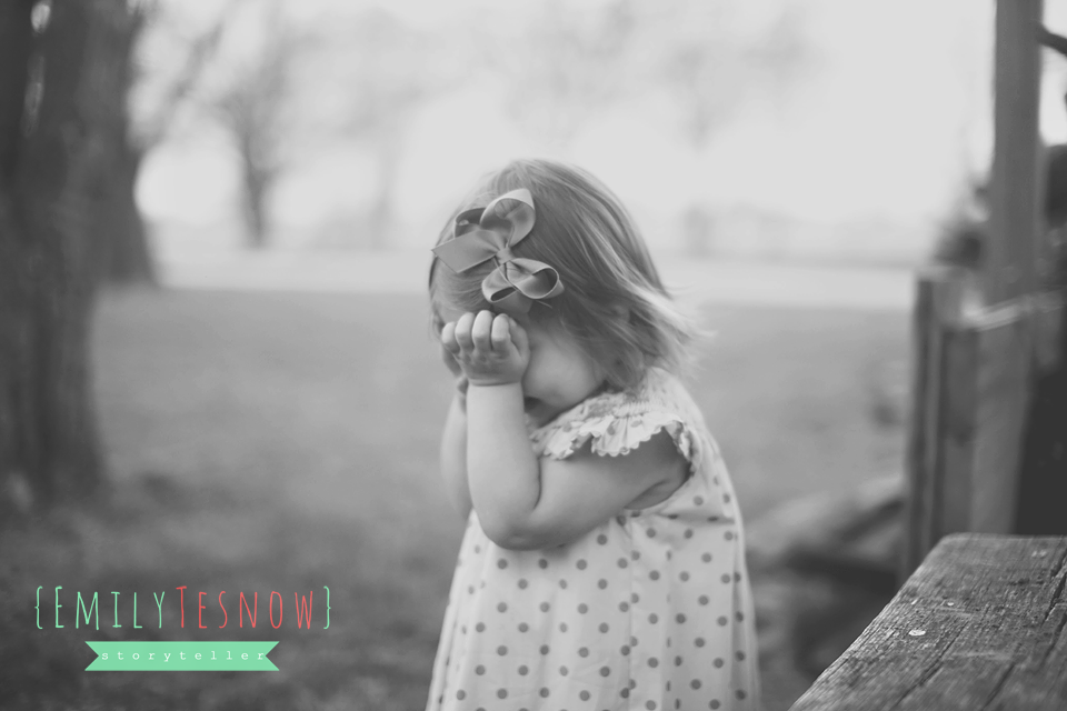 Lifestyle Portrait of little girl with a bow in her hair by Emily Tesnow Photography