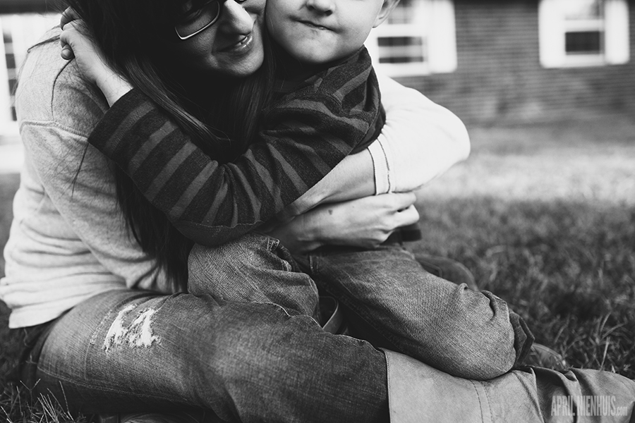 black and white pic of mom hugging son by April Nienhuis