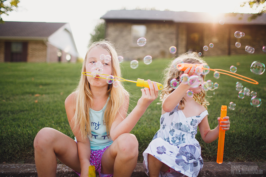 kids blowing bubbles outside photograph by April Nienhuis
