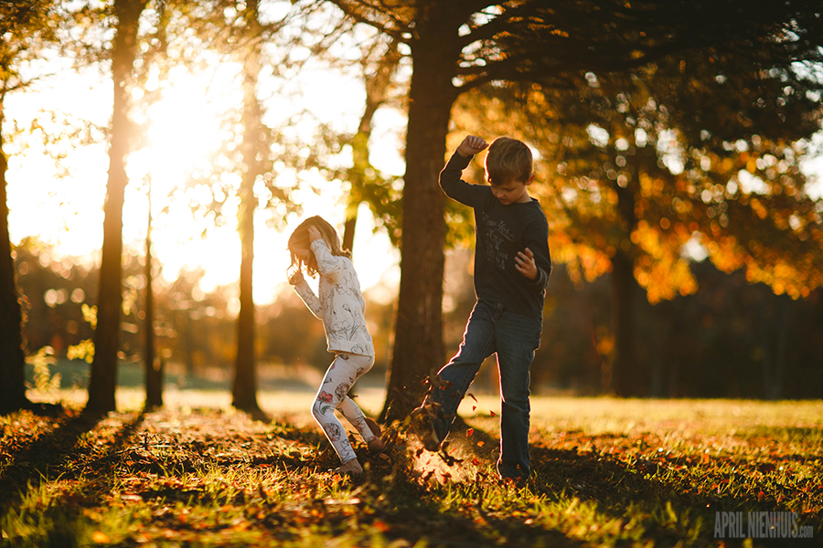 two kids playing and kicking in the yard photo by April Nienhuis